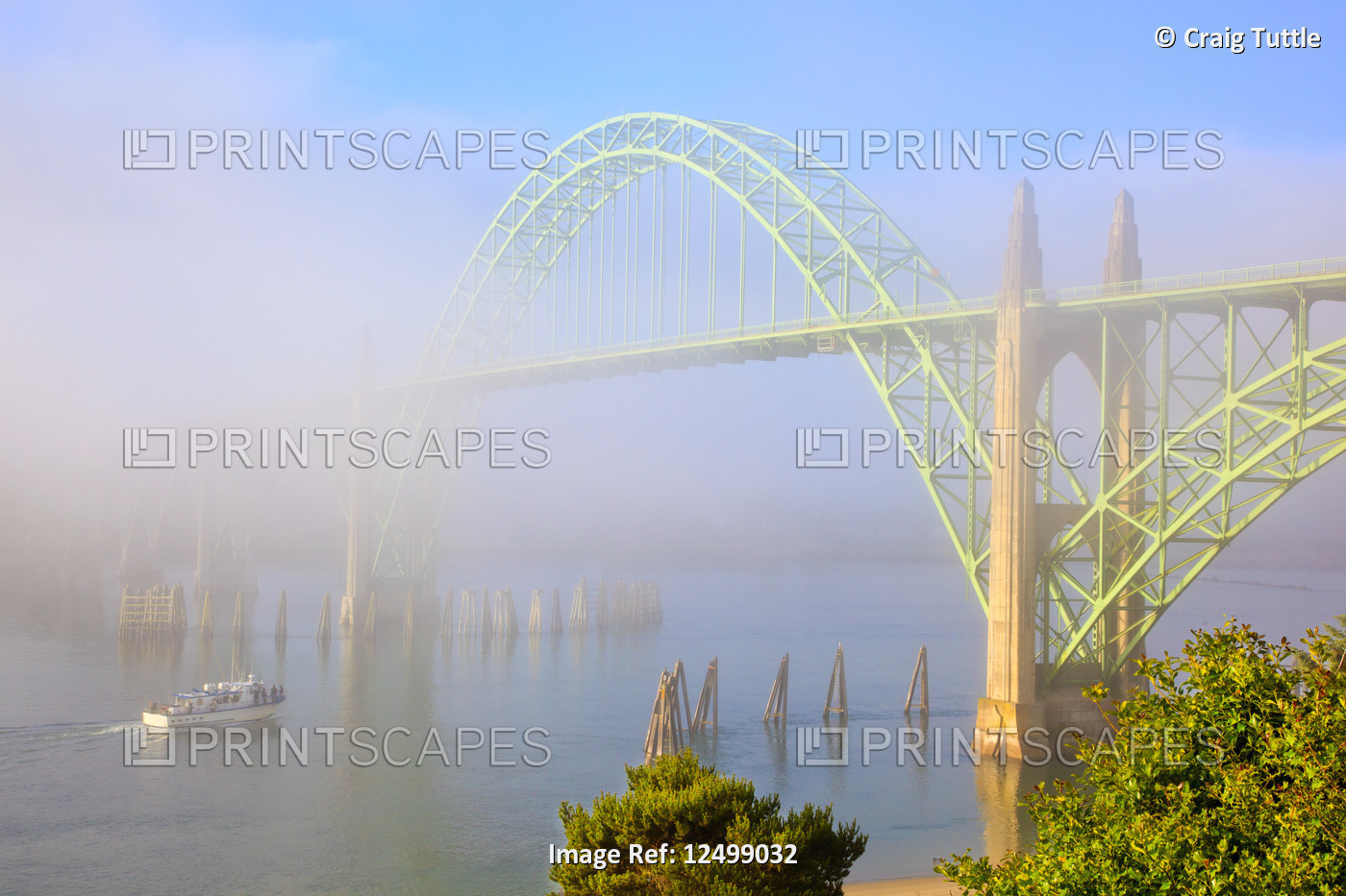 sunrise thru morning fog and Newport Bridge, Newport Harber, Oregon Coast. ...